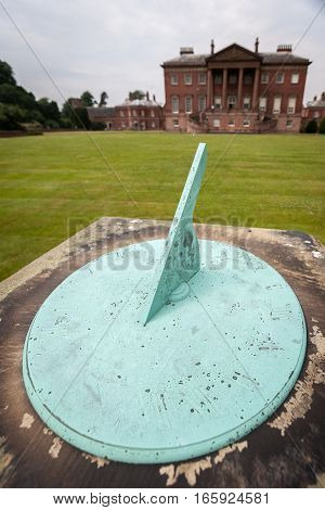 An old ornamental sun dial in the gardens of a grand old English stately home.