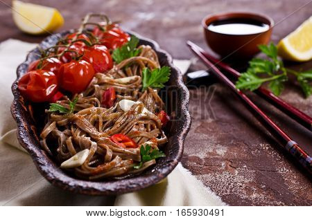 Buckwheat noodles with vegetables in a spicy sauce. Selective focus.