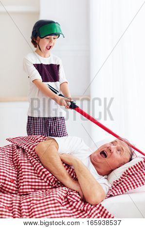 Naughty Yelling Grandson Waking Grandpa Up By Playing Around In Loud, Noisy Games