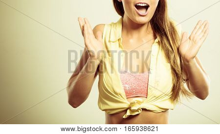 Shock suprise emotions. Suprised and shocked pin up woman. Young lady wearing yellow shirt and pink bra.