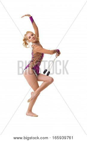 Young blonde girl in artistic embroidered violet sportsuit exercising with a mace studio shot