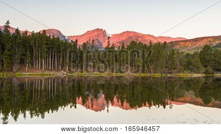 Hallett Peak reflection in Sprague Lake at dawn, in Rocky Mountain National Park, near Estes Park, Colorado.