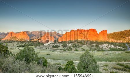 Dawn colors South Gateway, Signature, North Gateway, Kissing Camels, and Tower of Babel (named rock formations) in Garden of the Gods, Colorado Springs, Colorado.