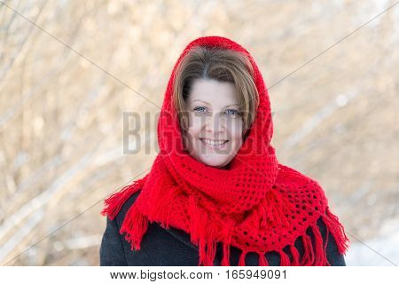 Russian woman with a red knitted shawl outdoors