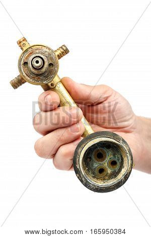 Old broken faucets for the shower in the hand isolated on a white background.