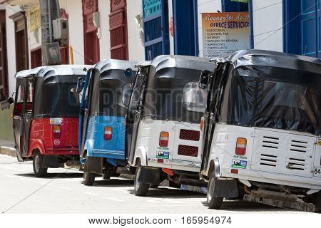 September 30, 2016 El Jardin, Colombia: small three wheeled motorized taxis called 'moto raton' waiting for customers