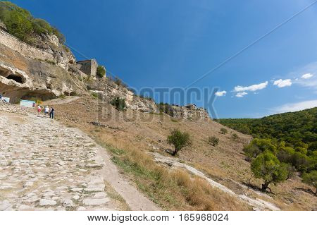 BAKHCHISARAY REPUBLIC of CRIMEA RUSSIA - SEPTEMBER 13.2016: Tourists climb to the entrance in the medieval fortress town Chufut-Kale