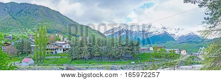 The green banks of Mestiachala river with the snowy Banguriani mountain range on the background Mestia Upper Svaneti Georgia.