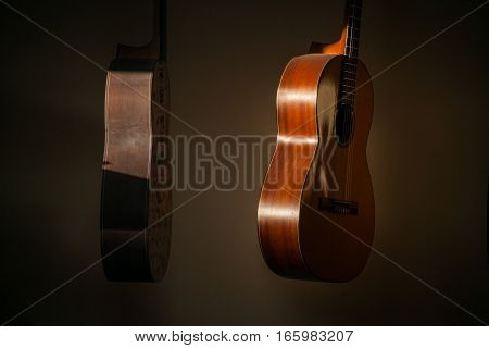 a row of classical unfinished guitar at workshop in sunlight.