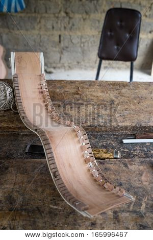 wooden piece of classical guitar in luthier's shop Ecuador