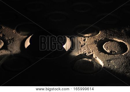 Close-up shot of a road lamp shining on a floor ringlet