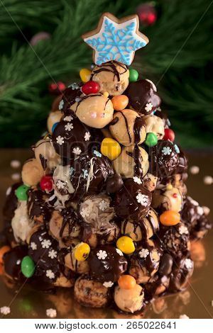 Christmas Croquembouche Cake Made With Profiteroles Decorated Chocolate Icing And Sweets, A Gingerbr