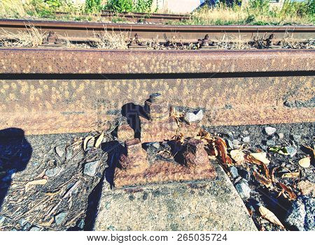 Ap With Nut And Screw On The Old Rusty Rail. Rusty Train Railway Detail, Oiled Sleepers And Stones B