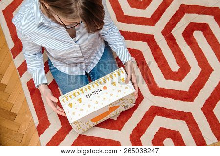 Paris, France - Jan 5, 2018: Overhead View From Above Of Curious Fashionable Woman Inspecting Cardbo