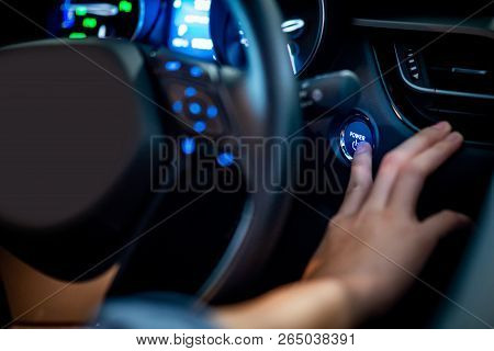 Male Driver Pushing Car Engine Start-stop Button Or Power Ignition Button By Steering Wheel In Moder