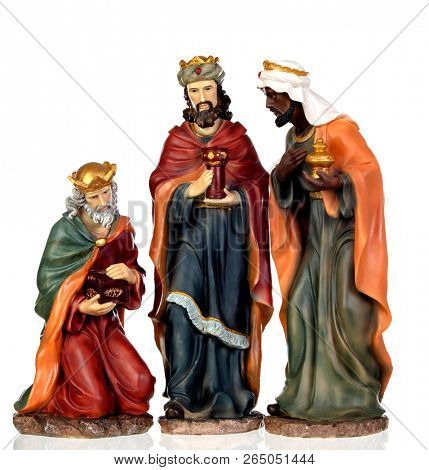 The three wise men. Ceramic figures isolated on white background