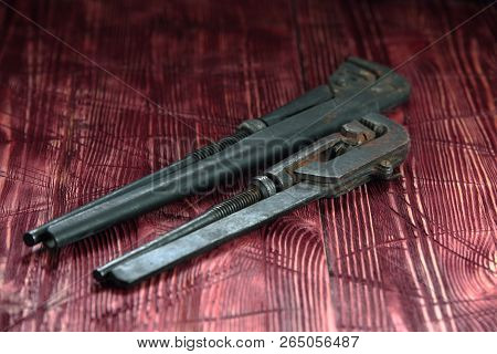 Tool On The Board Of Mahagany Background.