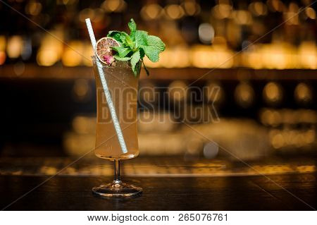 Cocktail Glass Filled With Tasty Sherry Cobbler Drink Decorated With Mint, Straw And Orange Slice On