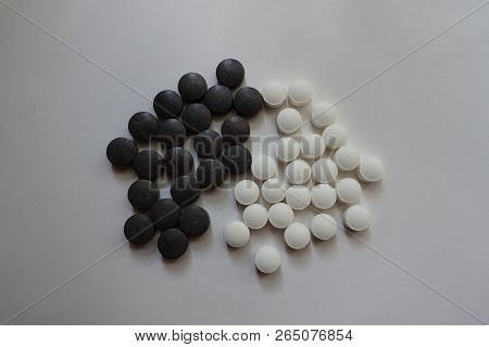 White Vitamin K And Black Chelated Iron Pills From Above