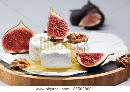 Camembert Cheese On Wrapping Paper With Figs
