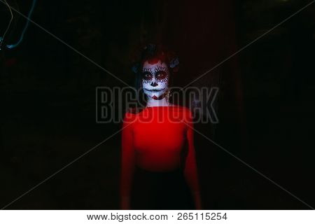 Blurry Body And Red Lantern. A Girl With A Painted Face Of A Skeleton, A Dead Zombie, In The City Du