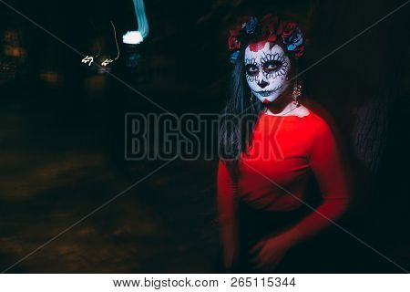 Blurry Body And Red Lantern. A Girl With A Painted Face Of A Skeleton, A Dead Zombie, In The City Du