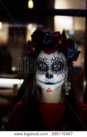 A Girl With A Painted Face Of A Skeleton, A Dead Zombie, In The City During The Day. Day Of All Soul