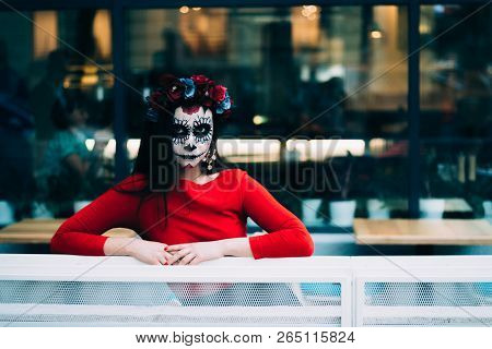 A Girl With A Painted Face Of A Skeleton, A Dead Zombie, In The City During The Day. Day Of All Soul