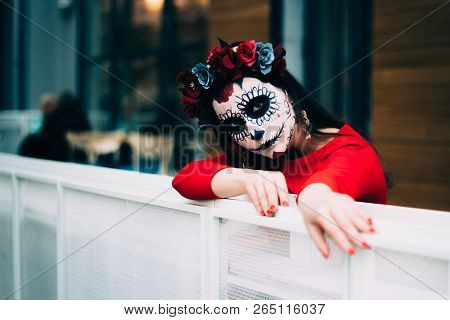 A Girl With A Painted Face Of A Skeleton, A Dead Zombie, In The City During The Day. Day Of All Soul