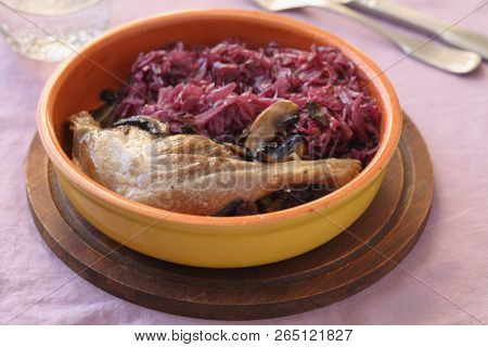 Roasted duck leg with mushrooms and braised blue cabbage