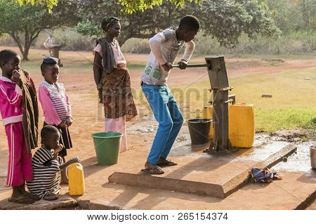 Ghana, Accra - January 02, 2017: African Ghana Family Take Water At The Well In Accra, Ghana