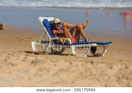 VILA DO BISPO, PORTUGAL - AUGUST 21, 2018: People at the famous beach of Salema in Vila do Bispo. This beach is a part of famous tourist region of Algarve.