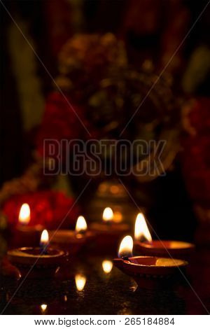 Diwali lights oil candles with Shiva Nataraja in the background for Maha Shivaratri,  India