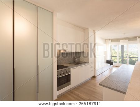 White kitchen with parquet. Nobody inside 