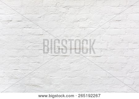 white painted brightly lit brick wall background or texture as a design element for industrial style compositings or as wallpaper