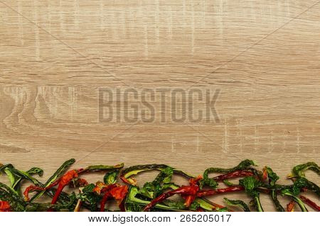 Dry Red And Green Bell Pepper On Wood Background. Space For Text