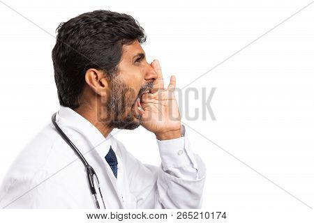 Isolated On White Background Side-view Of Indian Doctor Man Shouting With One Hand Around Mouth As B