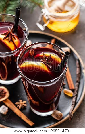 Hot Mulled Wine With Spices, Apple And Orange On Chrictmas Background. Copy Space.