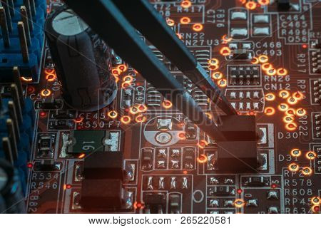 Smd Electronic Components Mounting. Tweezers Assemblinf Electronic Details On Pcb.