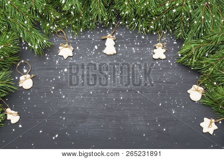 Christmas Decorations With Cookies, Fir Tree Branches And On Dark Background With Copyspace.