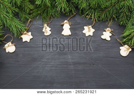 Christmas Decorations With Cookies, Fir Tree Branches And On Dark Background With Copyspace.