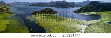 Aerial Panoramic View Of The Beautiful Landscape Of Lake Skadar In The Mountain On A Sunny Day. Mont