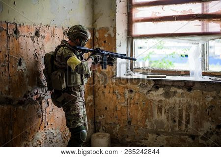 Sniper With Automatic Rifle By The Window In Building