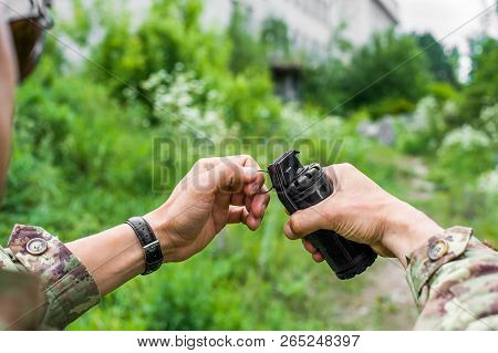 Male Hands Holding A Hand Grenade For Airsoft
