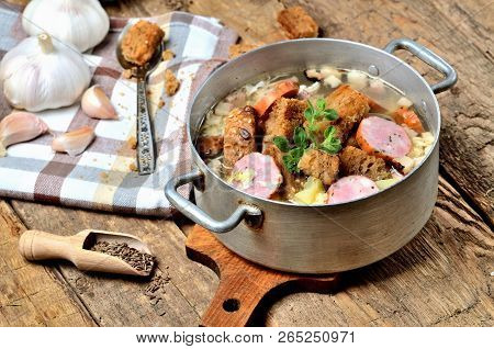 Old Saucepan With Garlic Soup, Fresh Garlic Bulbs, Cloves, Colored Pepper, Wooden Spoon, Croutons, L