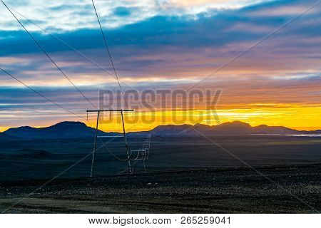 Light Of Sunset At The Mountain With The High Voltage Cables At The Highlands Of Iceland In Summer
