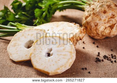 Celery Root With Leaves On Sackcloth Background. Close Up