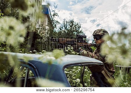 Military Man With Automatic Rifle And Rifle Scope