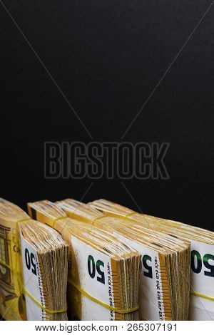 Pile Of 50 Real Euro Notes 50-euro Banknotes Under Rubber Band Isolated On Black. About 20000 Euros 