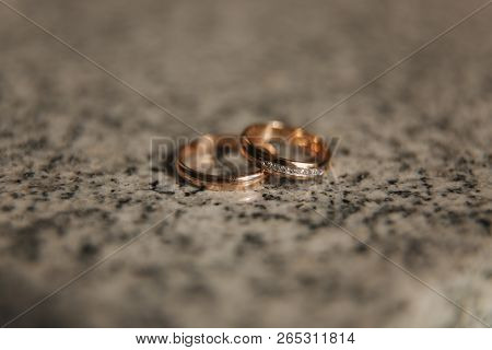 Wedding Rings On Table. Gold Rings With Diamond On Sun. Wedding Accsessories. Macro